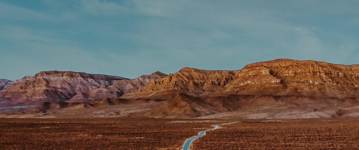 Aerial photo of paved road through the desert